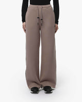 Pantaloni a gamba larga in scuba con piping in ecopelle