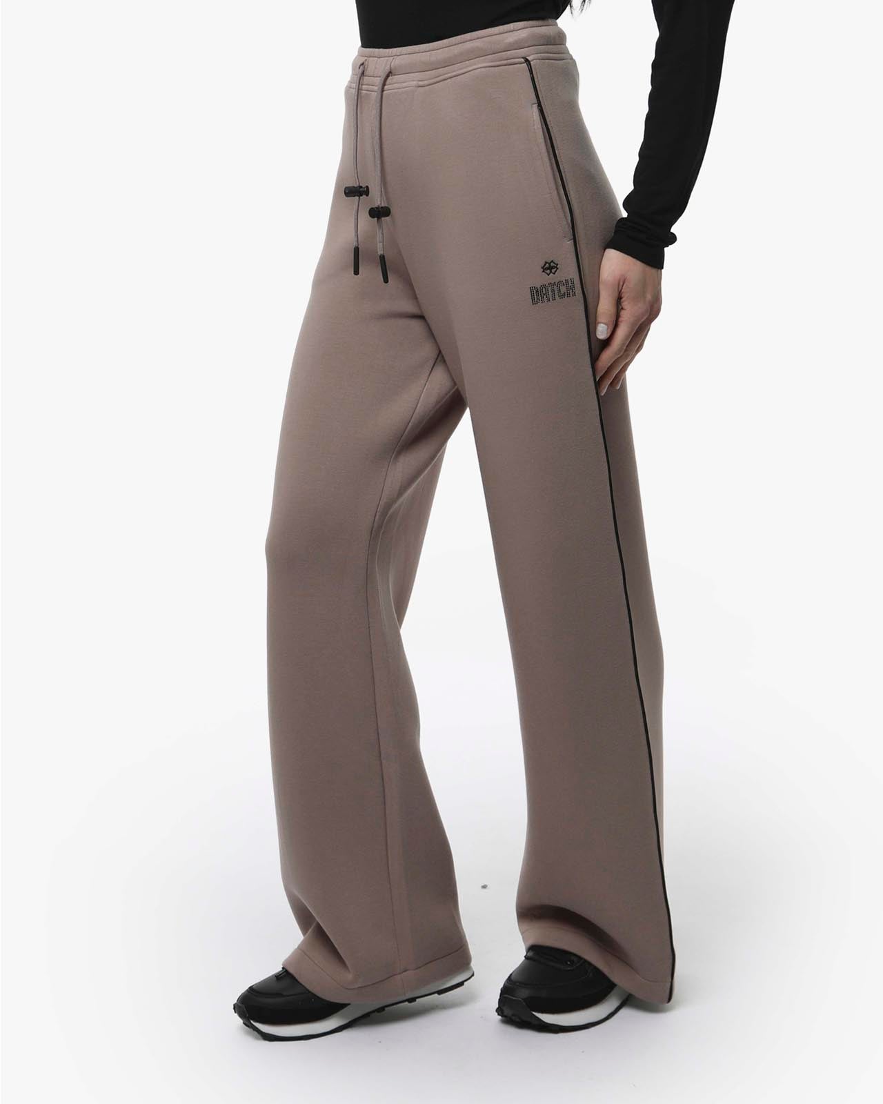 Pantaloni a gamba larga in scuba con piping in ecopelle