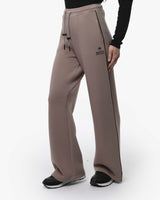 Pantaloni a gamba larga in scuba con piping in ecopelle