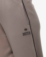 Pantaloni a gamba larga in scuba con piping in ecopelle