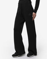 Pantaloni a gamba larga in scuba con piping in ecopelle