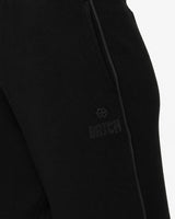 Pantaloni a gamba larga in scuba con piping in ecopelle