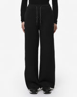 Pantaloni a gamba larga in scuba con piping in ecopelle