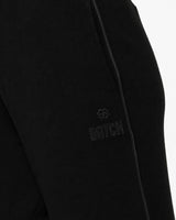 Pantaloni a gamba larga in scuba con piping in ecopelle